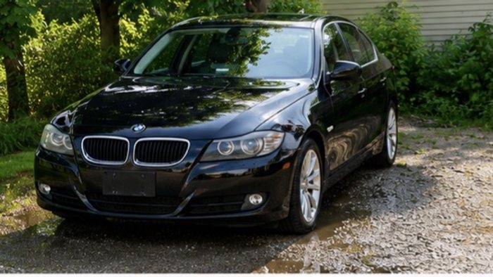Freshly washed black BMW 3 Series after an exterior hand detail