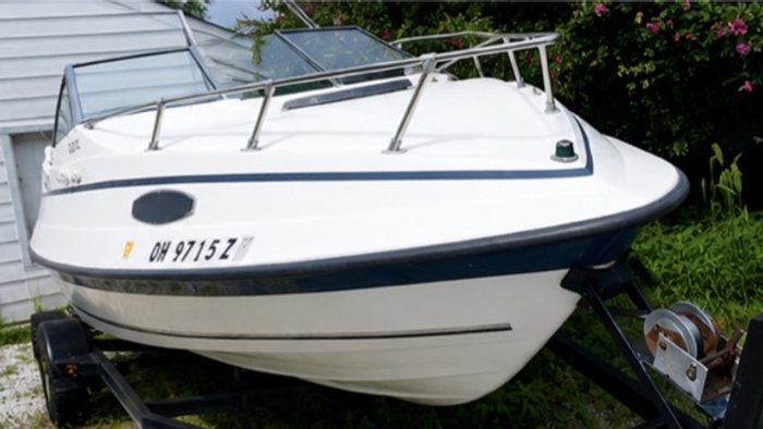 Cleaned white and navy boat on its trailer, detailed inside and out